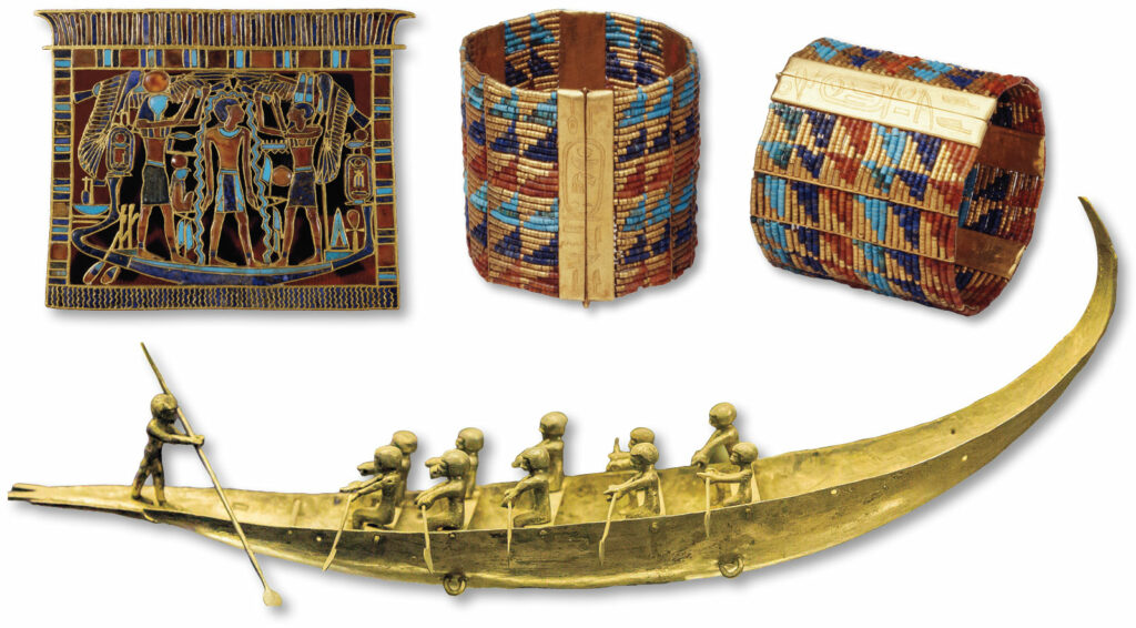 Gold breastplate, beaded bracelets, and silver boat model