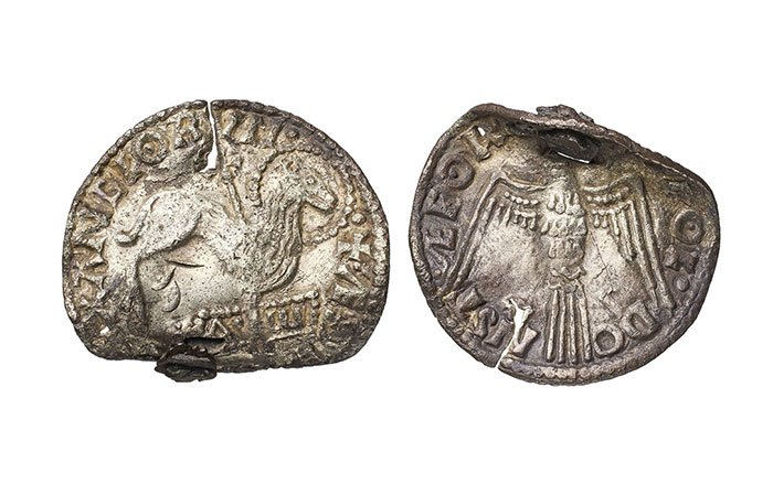 Coins decorated with images of a lamb and cross (left) and a dove (right)