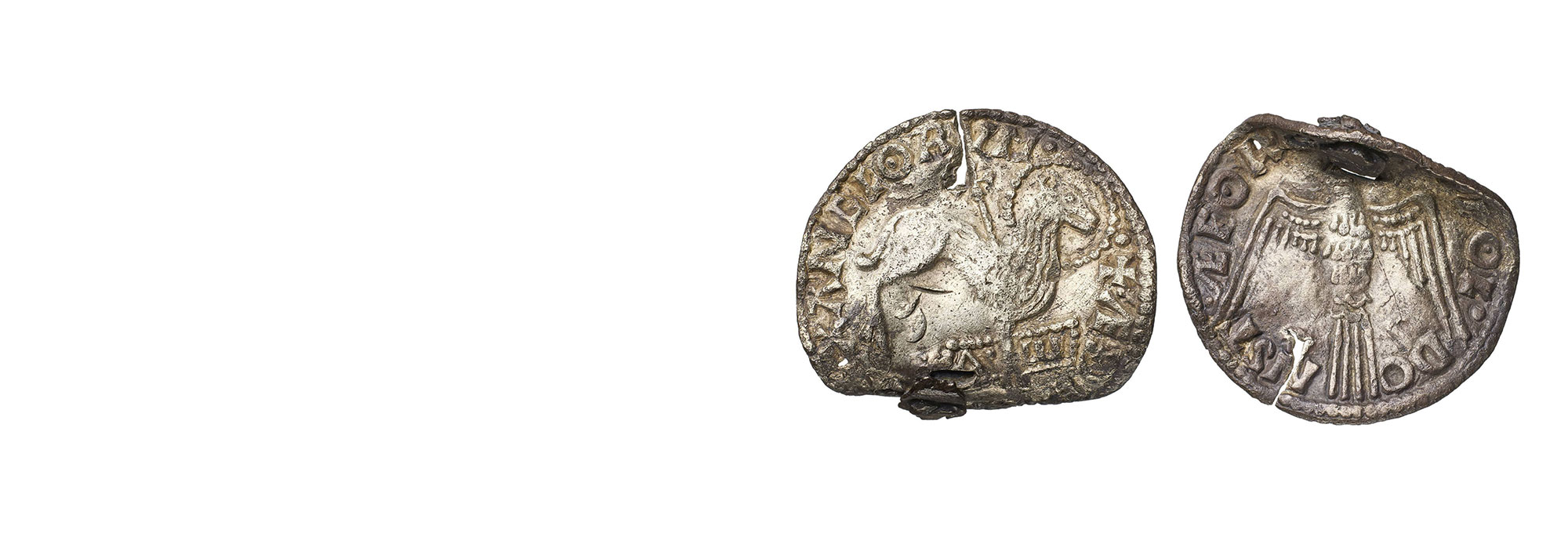 Coins decorated with images of a lamb and cross (left) and a dove (right)