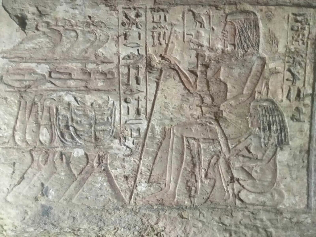 Carving on tomb wall depicting a seated woman, Saqqara, Egypt