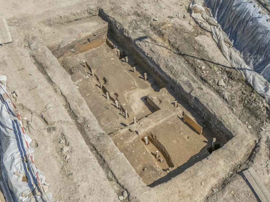 Remains of the timber-and-earth rampart of the first military camp at Vindonissa, Switzerland. Modern squared timbers have been placed in the postholes to improve visibility.