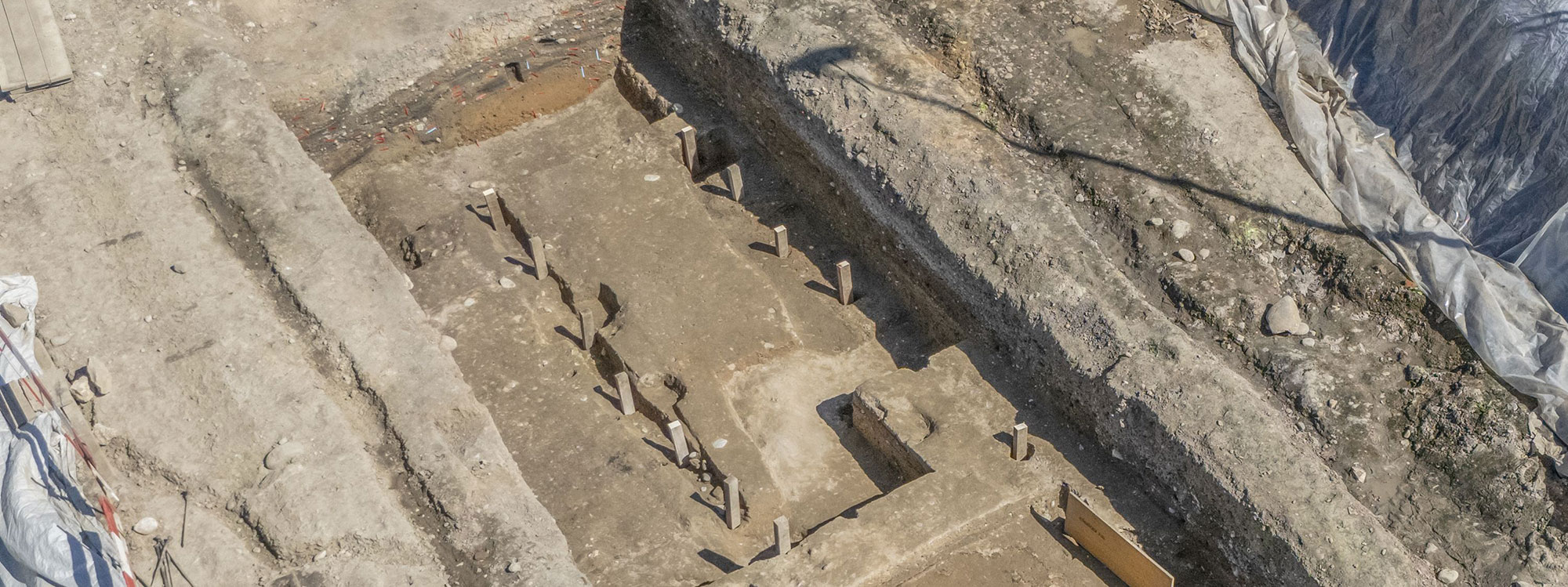 Remains of the timber-and-earth rampart of the first military camp at Vindonissa, Switzerland. Modern squared timbers have been placed in the postholes to improve visibility.
