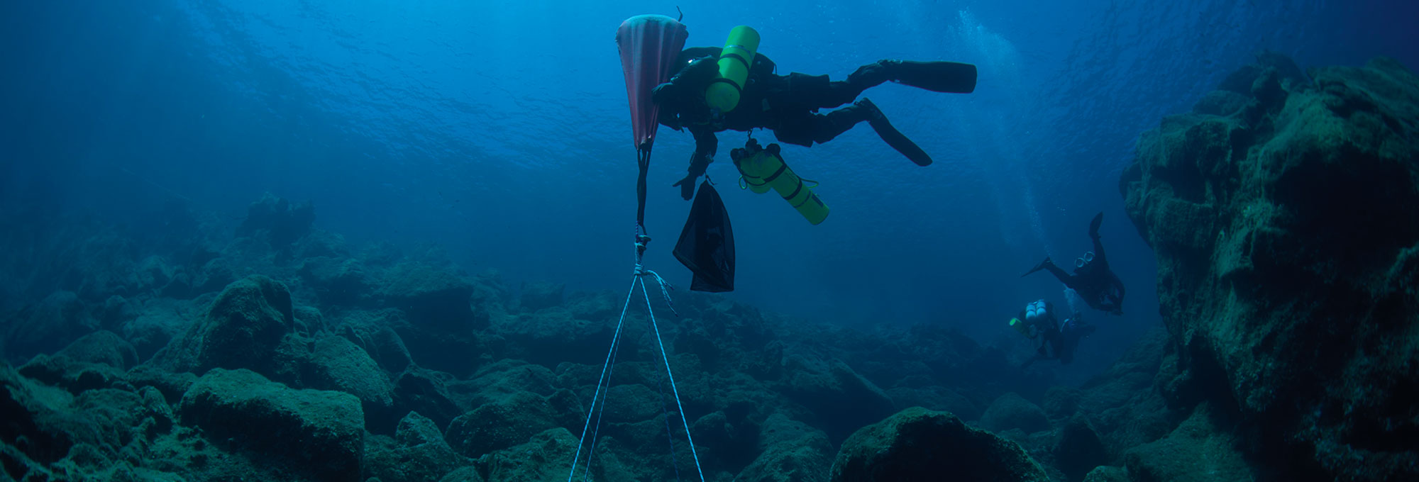 A diver lifts a section of hull from a ship that sank off the eastern coast of the Greek island of Antikythera