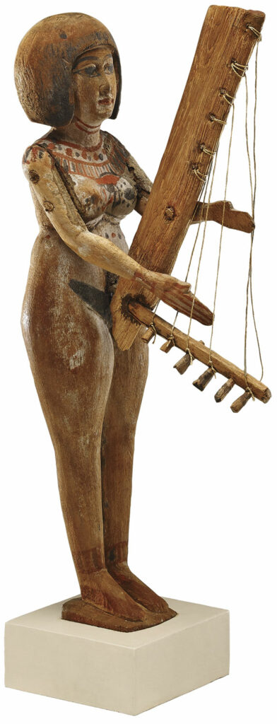 Wooden figurine of a woman playing an angular harp