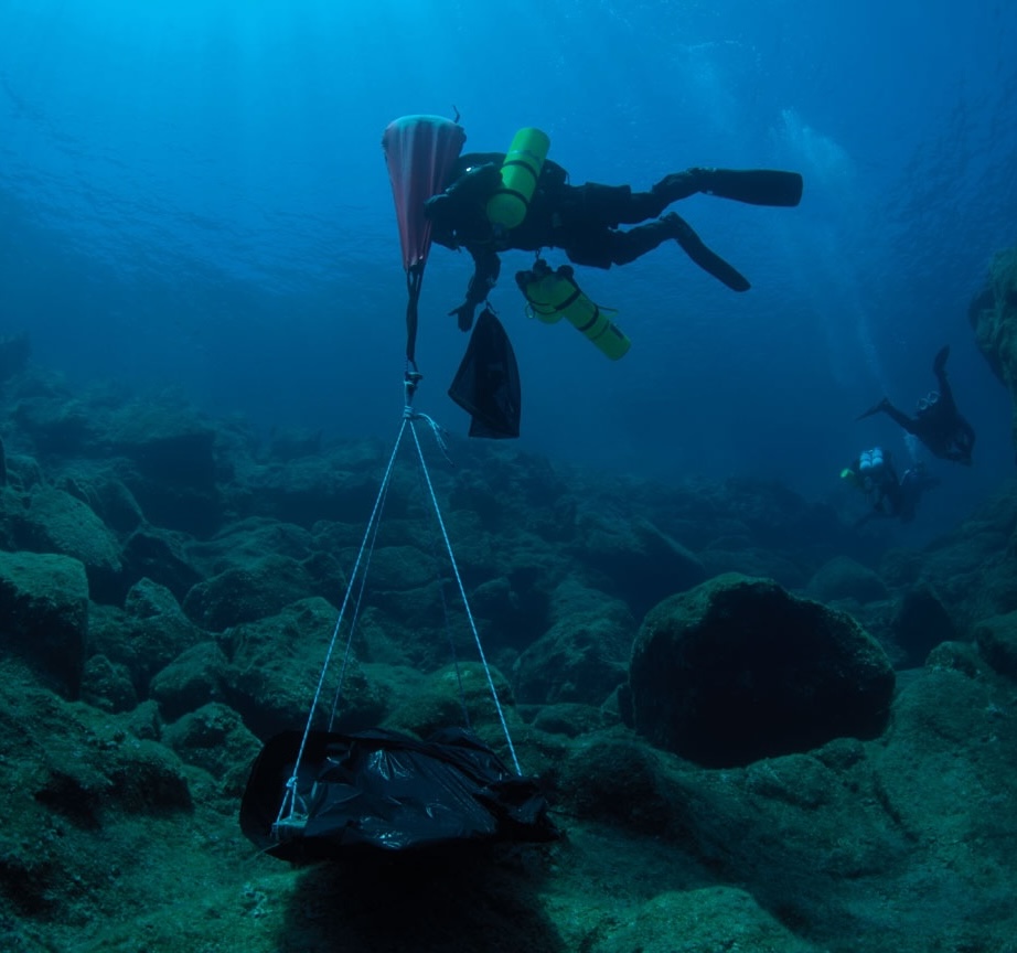 A diver lifts a section of hull from a ship that sank off the eastern coast of the Greek island of Antikythera