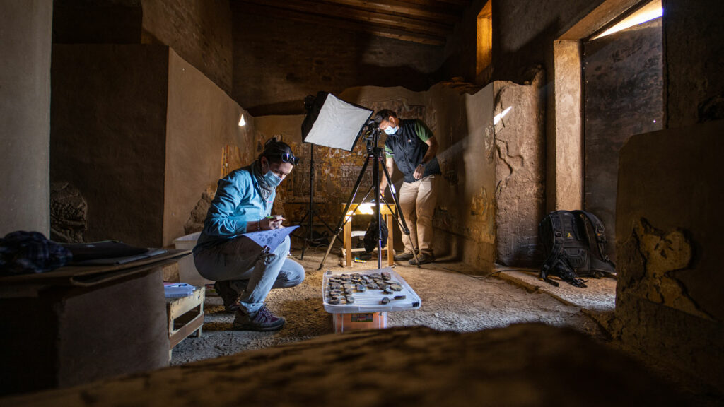 Egyptologist Kathrin Gabler (left) and a member of her team study wall painting fragments in Ipuy's chapel