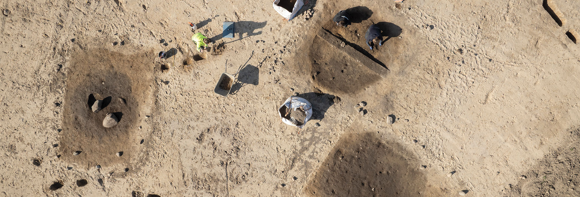 Aerial view of excavation of three pit house foundations, Soften, Denmark